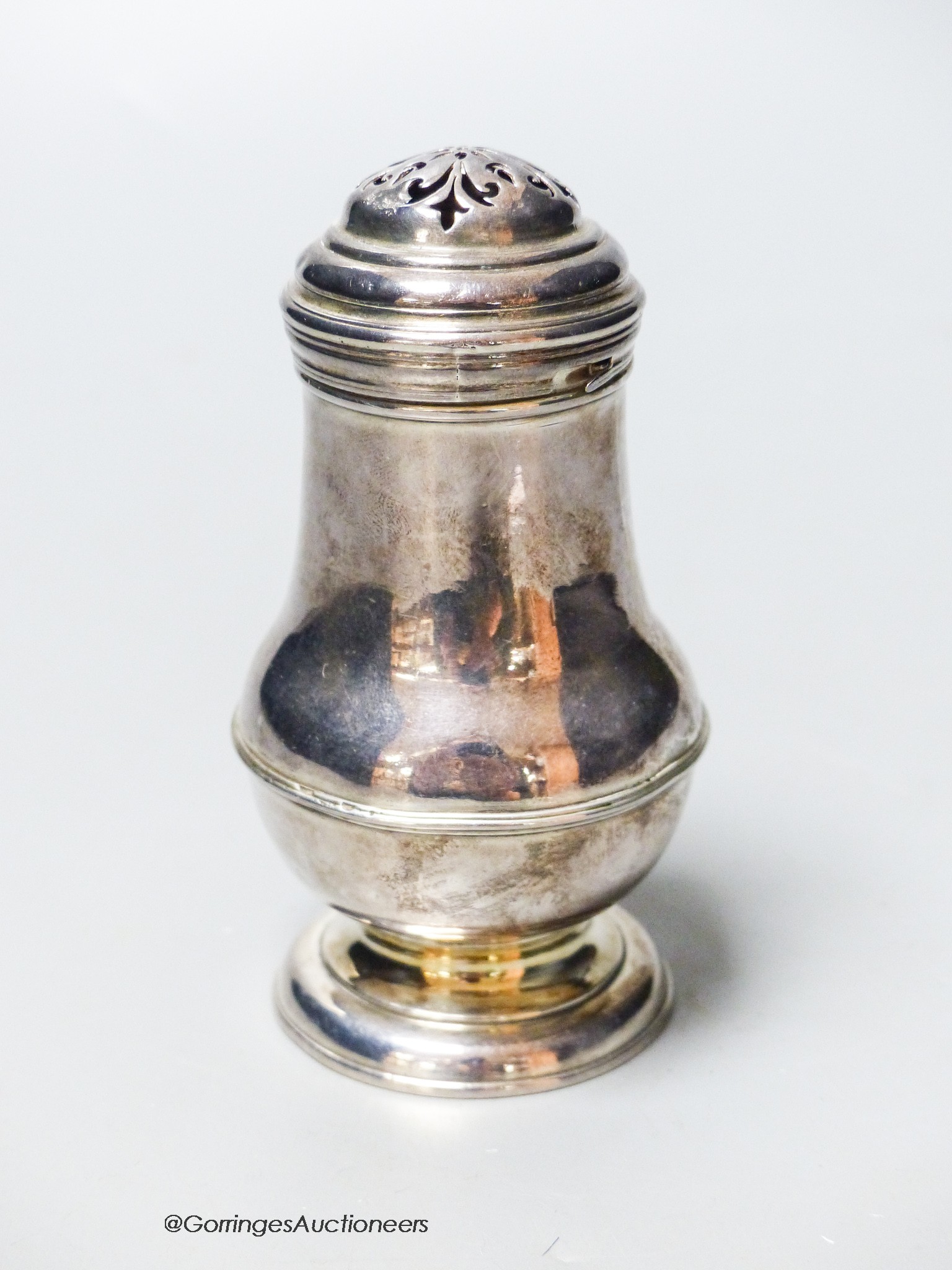 A George I Britannia standard silver bun topped baluster pepper, by George Greenhill Jones, London, 1720, 10.4cm, 3oz.